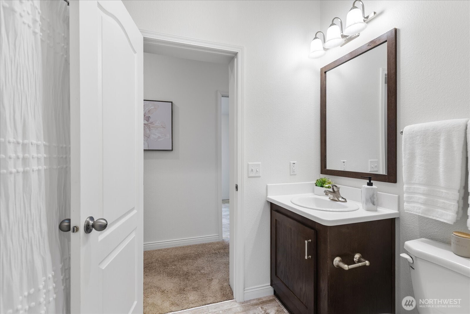 23825 15th Avenue Southeast, Unit 169 Bothell, WA 98021 - Photo 19 of 25 a bathroom with a sink vanity toilet and mirror