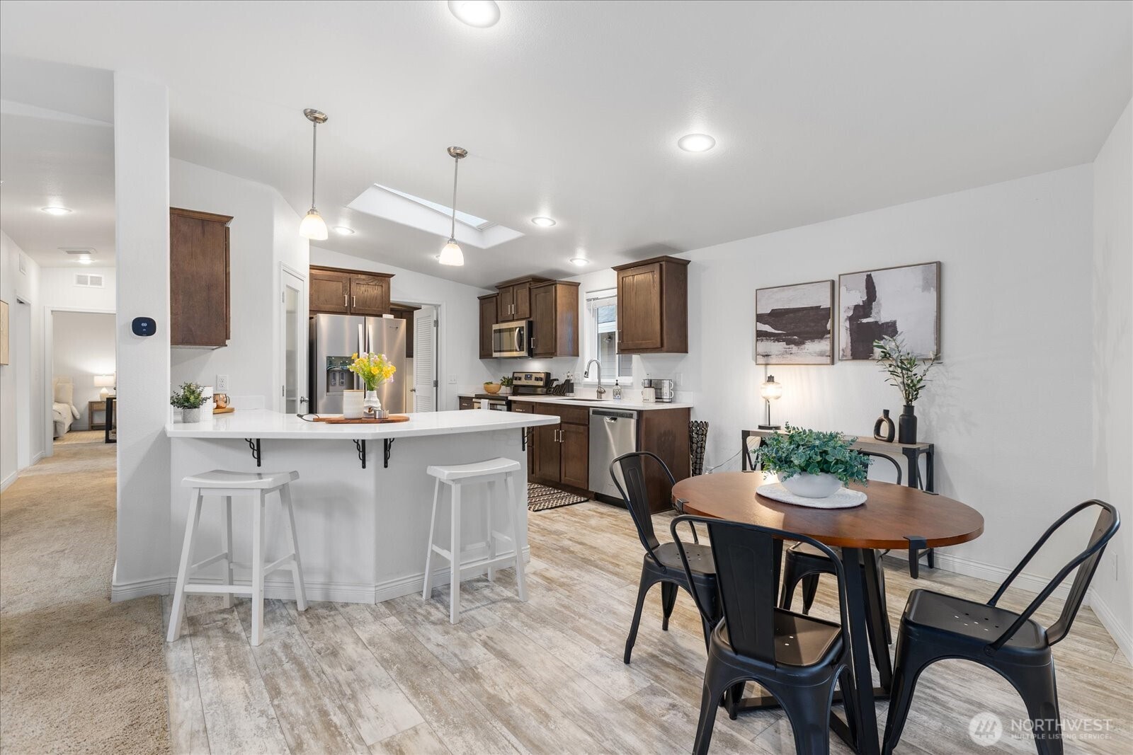 23825 15th Avenue Southeast, Unit 169 Bothell, WA 98021 - Photo 7 of 25 a kitchen with kitchen island a dining table and chairs
