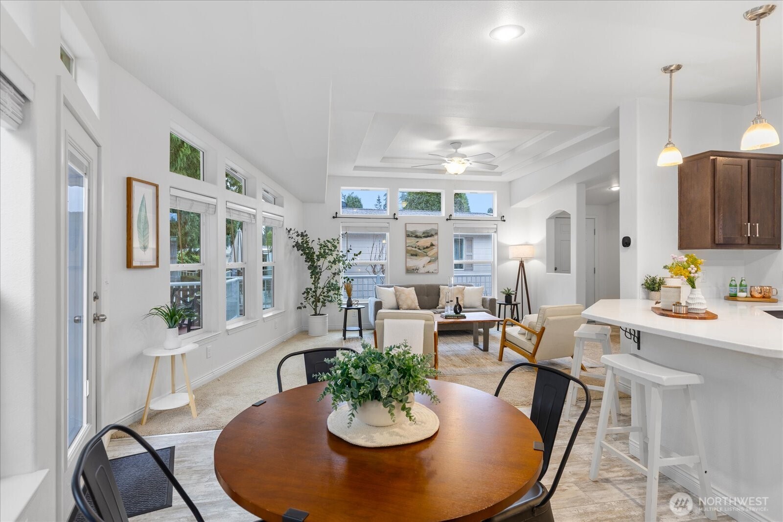 23825 15th Avenue Southeast, Unit 169 Bothell, WA 98021 - Photo 9 of 25 a dining room with furniture a kitchen view and wooden floor