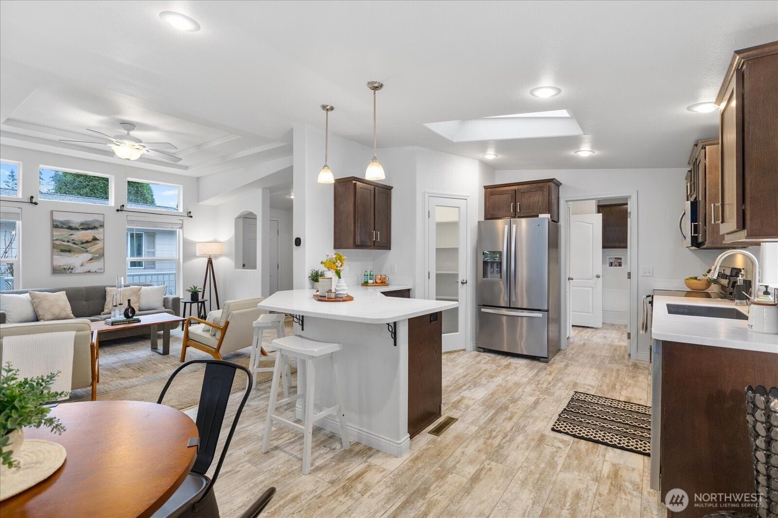 23825 15th Avenue Southeast, Unit 169 Bothell, WA 98021 - Photo 10 of 25 a kitchen with stainless steel appliances kitchen island granite countertop a sink refrigerator and cabinets