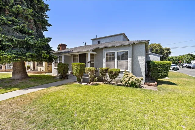 a view of a house with backyard porch and sitting area