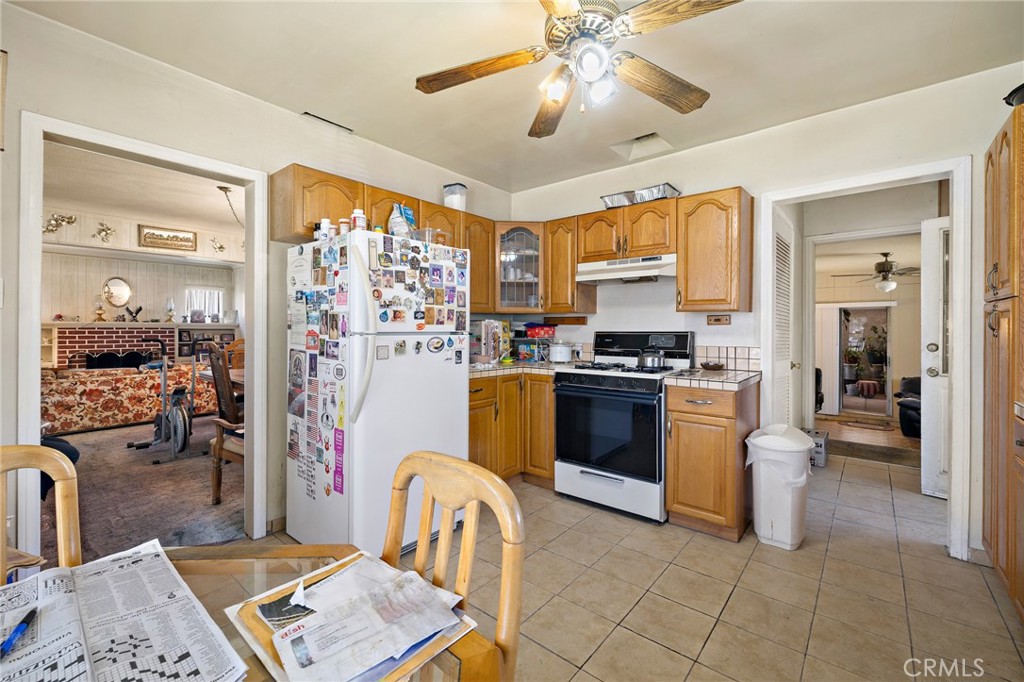 301 South Harris Avenue Compton, CA 90221 - Photo 11 of 30 a kitchen with stainless steel appliances granite countertop a stove a sink dishwasher and a refrigerator with wooden floor
