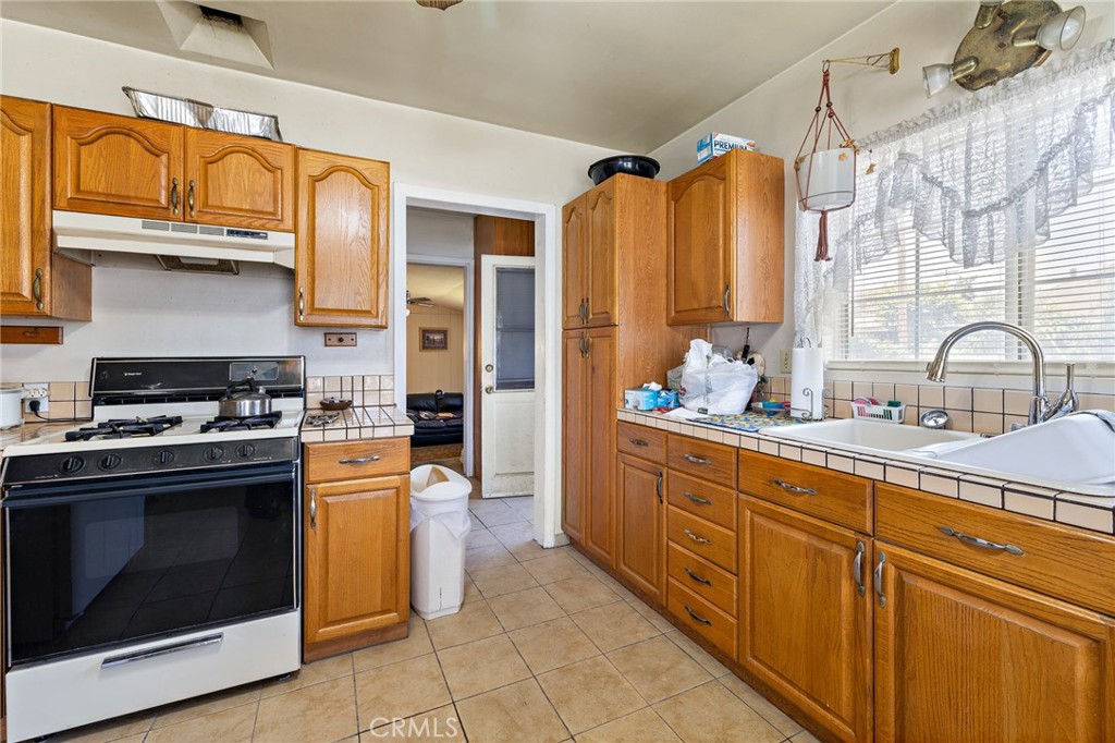 301 South Harris Avenue Compton, CA 90221 - Photo 12 of 30 a kitchen with stainless steel appliances granite countertop a stove and a sink