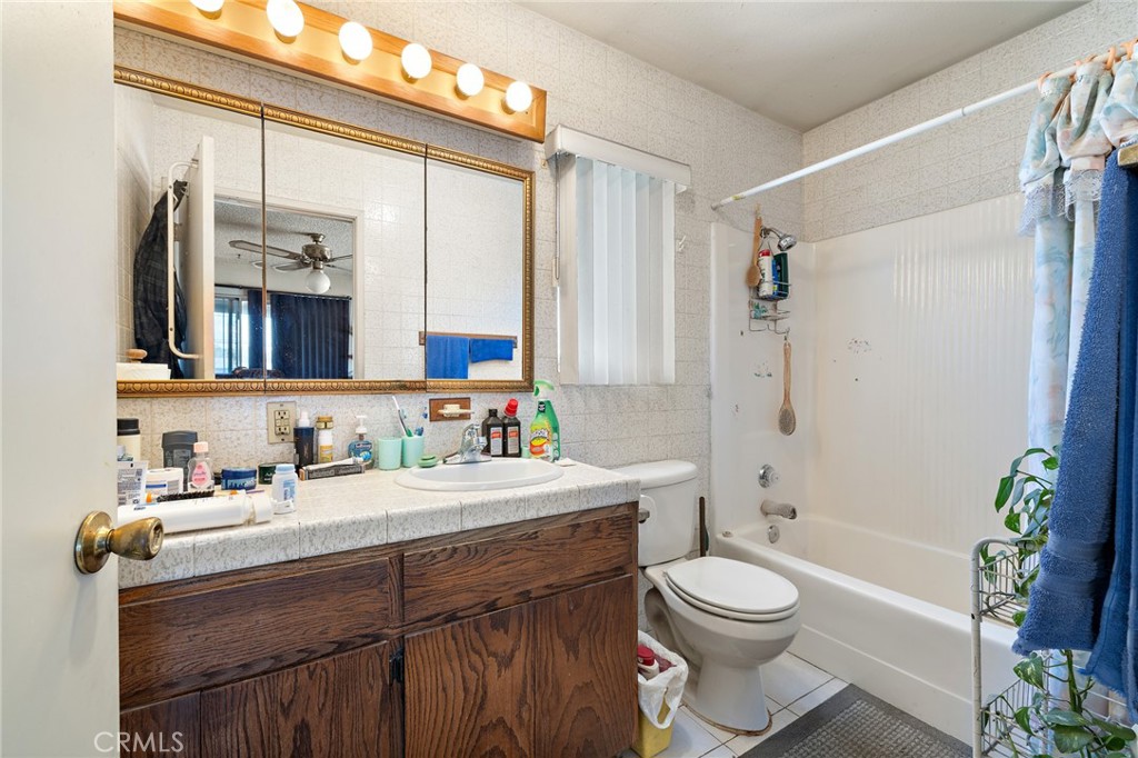 301 South Harris Avenue Compton, CA 90221 - Photo 15 of 30 a bathroom with a sink a toilet a mirror a vanity and shower