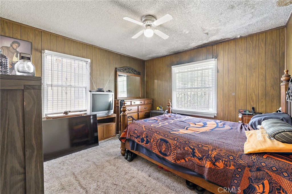 301 South Harris Avenue Compton, CA 90221 - Photo 16 of 30 a bedroom with a bed and wooden floor