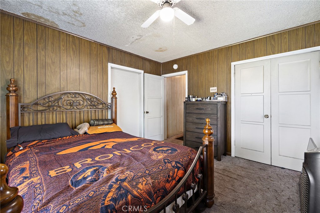 301 South Harris Avenue Compton, CA 90221 - Photo 17 of 30 a bedroom with a bed and a chandelier