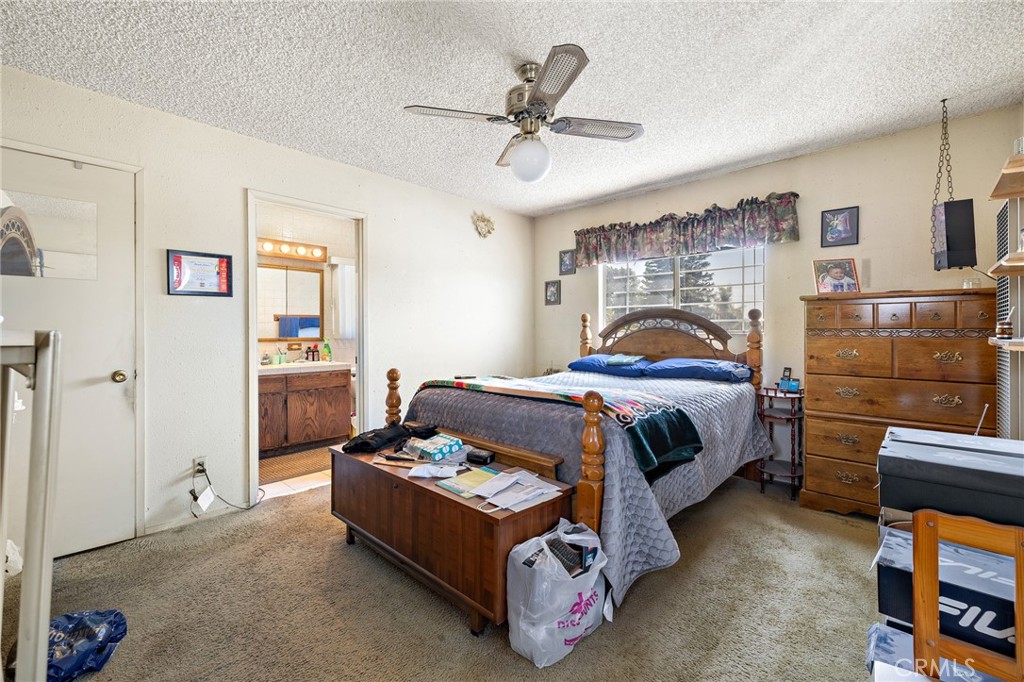 301 South Harris Avenue Compton, CA 90221 - Photo 19 of 30 a bedroom with a bed and a chandelier
