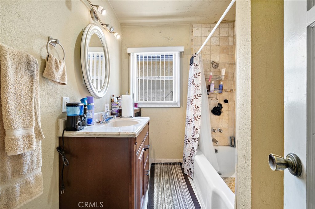 301 South Harris Avenue Compton, CA 90221 - Photo 21 of 30 a bathroom with a sink a mirror a vanity and a shower