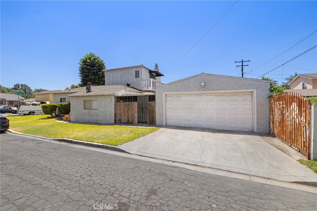 301 South Harris Avenue Compton, CA 90221 - Photo 4 of 30 a front view of a house with a yard and garage