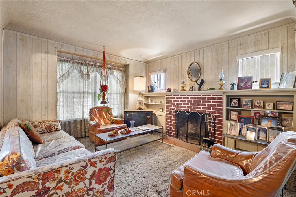 301 South Harris Avenue Compton, CA 90221 - Photo 6 of 30 a living room with furniture a fireplace and a window
