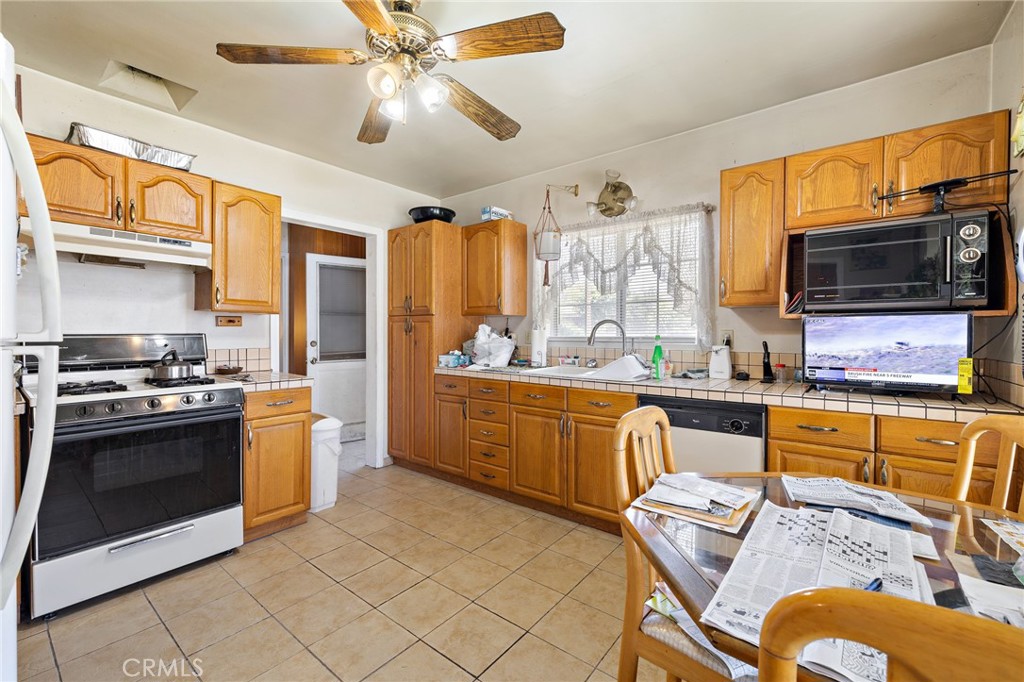 301 South Harris Avenue Compton, CA 90221 - Photo 10 of 30 a kitchen with stainless steel appliances granite countertop a stove and a sink
