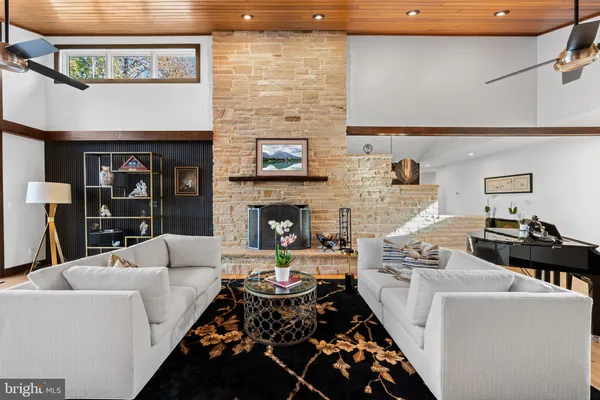 a living room with furniture and a floor to ceiling window