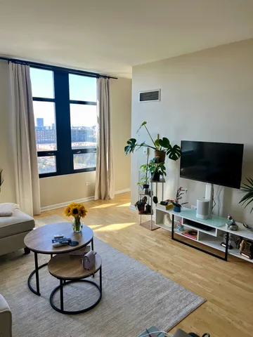 a living room with furniture gym equipment and a flat screen tv