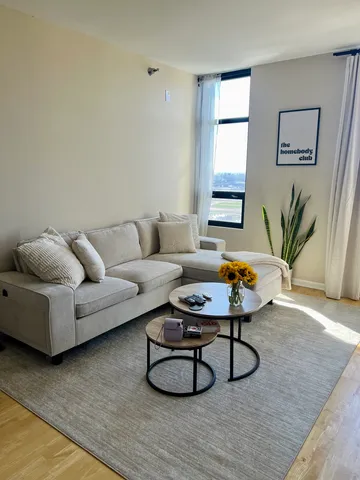 a living room with furniture and wooden floor