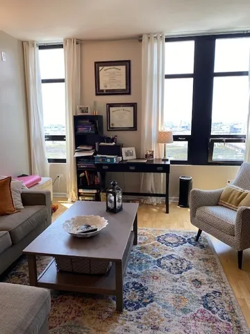 a living room with furniture and a large window