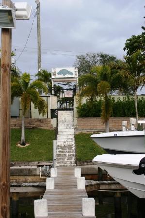 Unassigned Southeast Robertson Road Stuart, FL 34997 - Photo 4 of 5 a front view of a house with a garden and trees