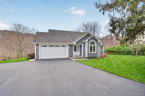 a house with huge green field in front of it