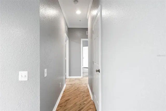 a view of a hallway with wooden floor
