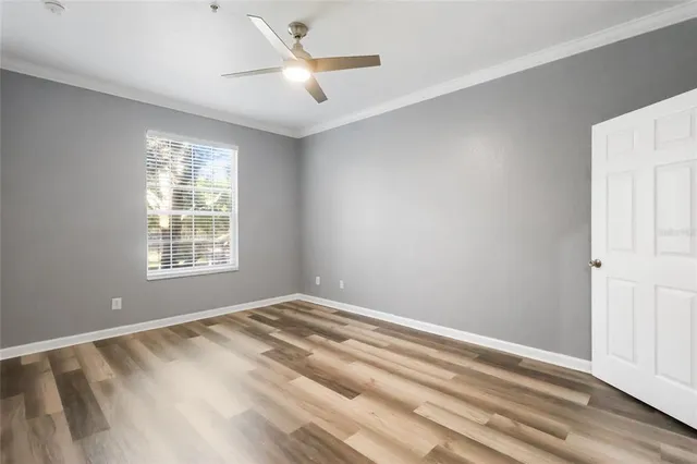 a view of room with window and ceiling fan