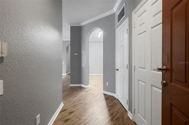 a view of a hallway with wooden floor
