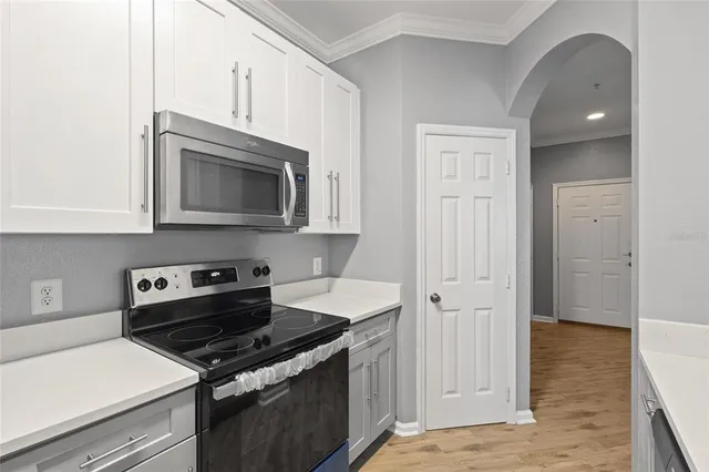 a kitchen with stainless steel appliances granite countertop a stove and a microwave