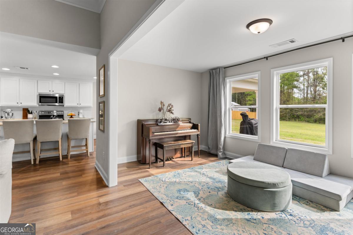 187 Loch Way Eatonton, GA 31024 - Photo 11 of 49 a living room with a couch and a table