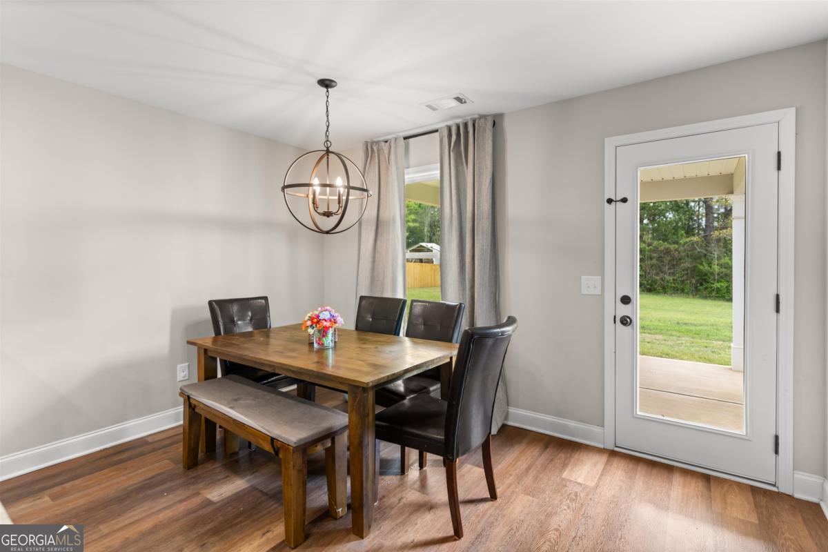 187 Loch Way Eatonton, GA 31024 - Photo 14 of 49 a view of a dining room with furniture window and wooden floor