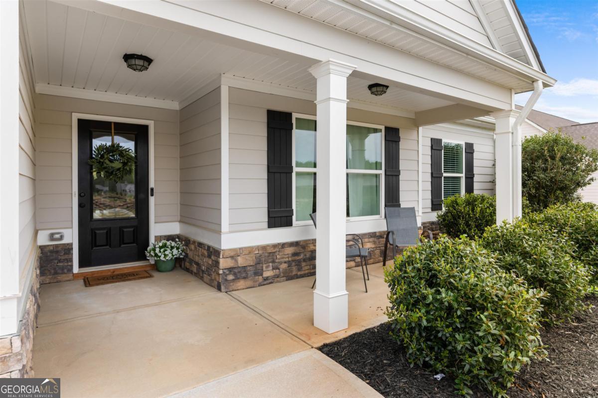 187 Loch Way Eatonton, GA 31024 - Photo 2 of 49 a front view of a house with a plants