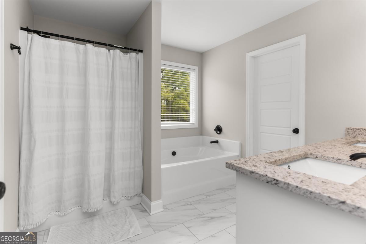 187 Loch Way Eatonton, GA 31024 - Photo 21 of 49 a bathroom with a granite countertop sink and a mirror