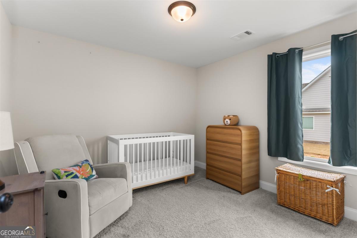 187 Loch Way Eatonton, GA 31024 - Photo 24 of 49 a bedroom with a bed and a window