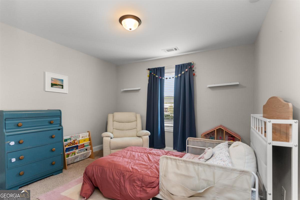 187 Loch Way Eatonton, GA 31024 - Photo 25 of 49 a bedroom with a bed and furniture