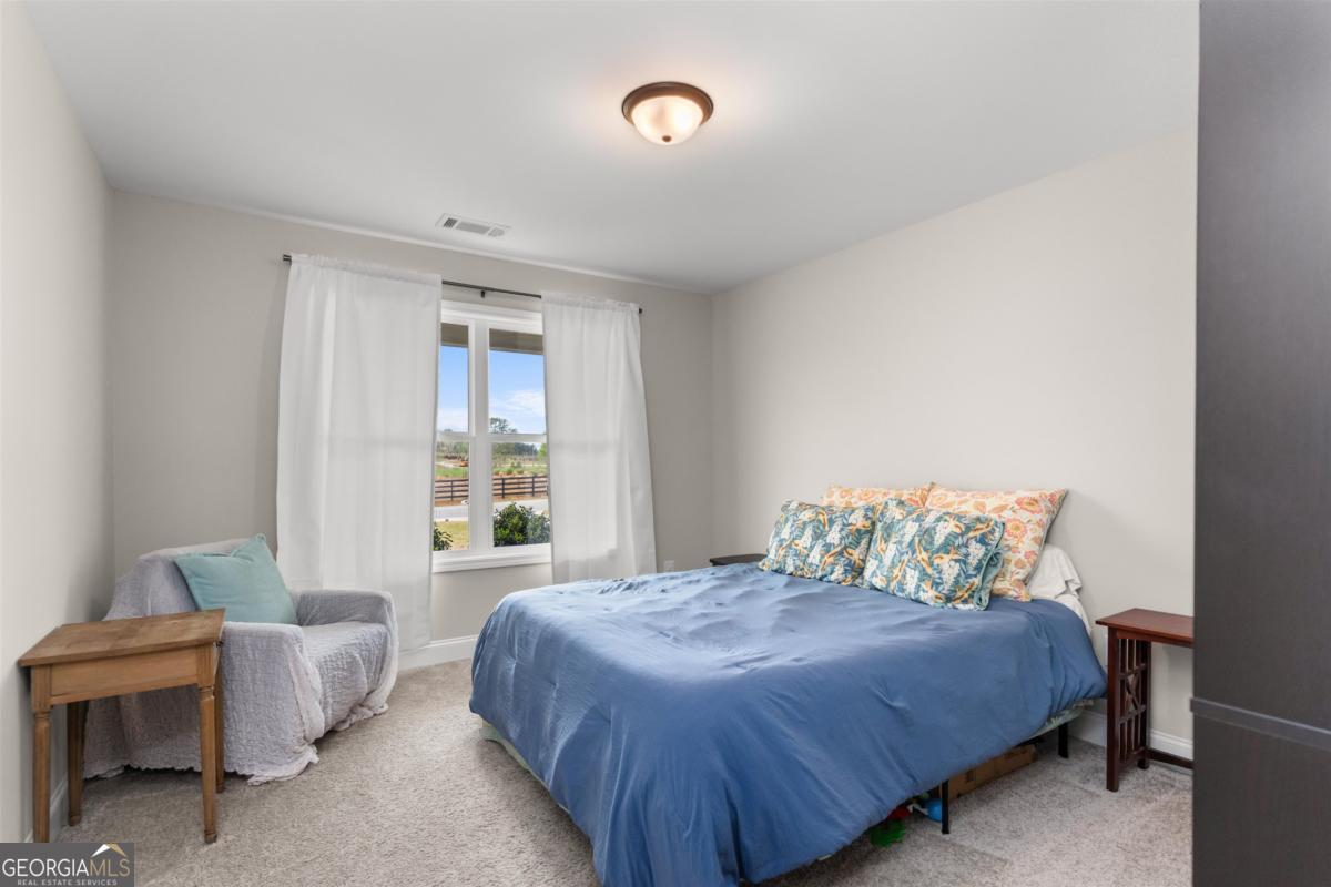 187 Loch Way Eatonton, GA 31024 - Photo 26 of 49 a bedroom with a bed and a window
