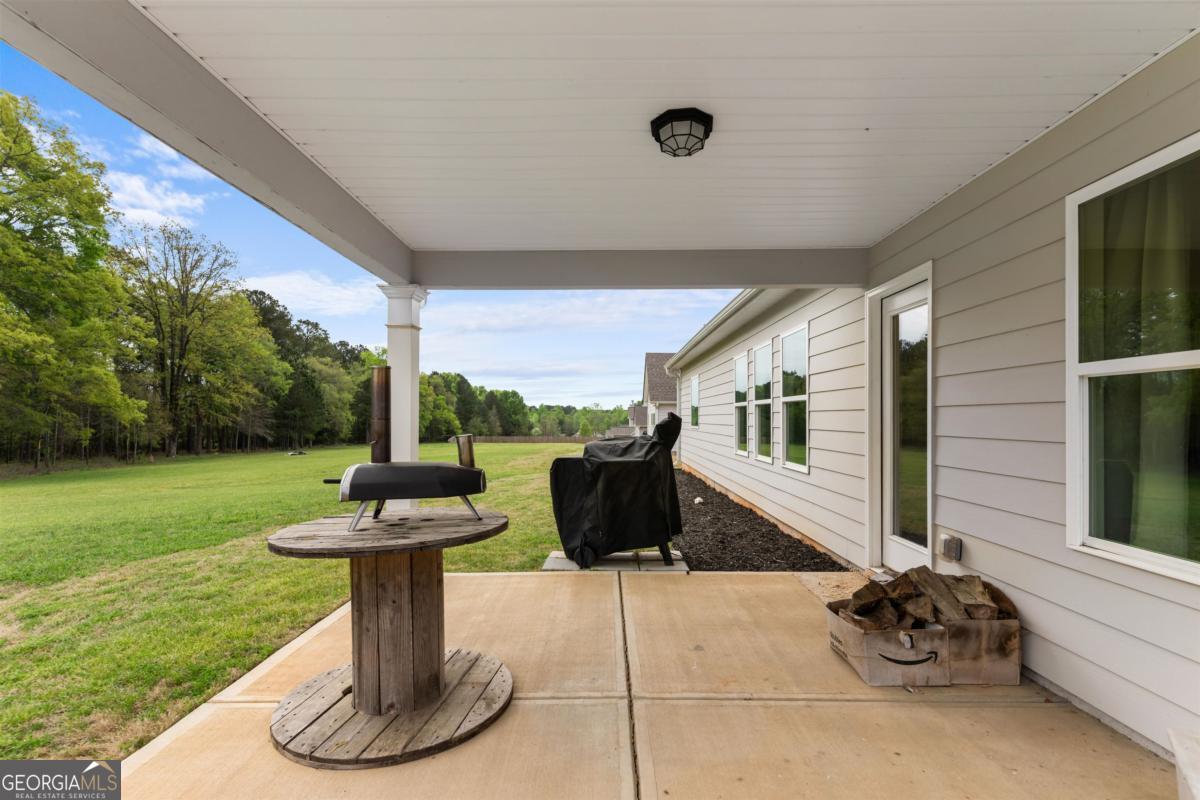 187 Loch Way Eatonton, GA 31024 - Photo 29 of 49 a view of a house with backyard sitting area and garden