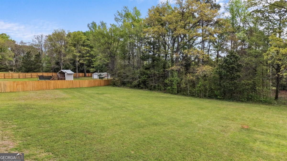 187 Loch Way Eatonton, GA 31024 - Photo 40 of 49 a view of a green field with trees in the background