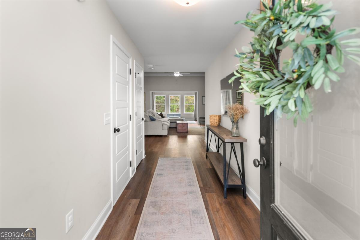 187 Loch Way Eatonton, GA 31024 - Photo 4 of 49 a view of a hallway with wooden floor and a potted plant