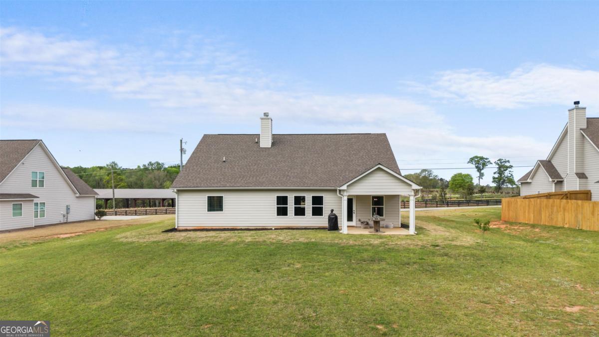 187 Loch Way Eatonton, GA 31024 - Photo 42 of 49 a front view of a house with a garden and deck