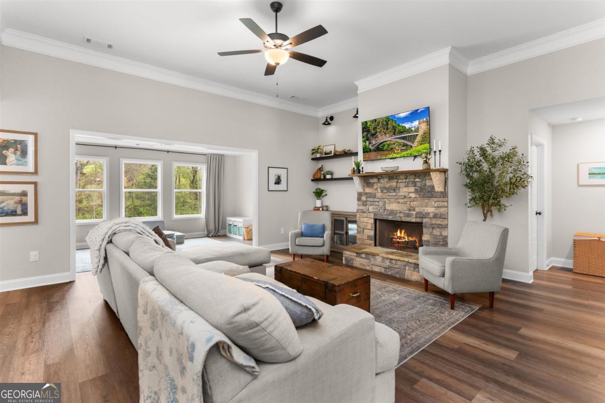 187 Loch Way Eatonton, GA 31024 - Photo 7 of 49 a living room with furniture a fireplace and a flat screen tv