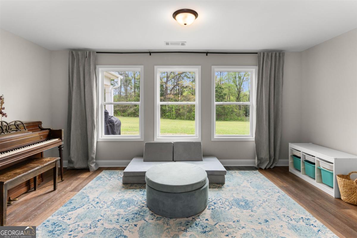 187 Loch Way Eatonton, GA 31024 - Photo 10 of 49 a living room with furniture and a window