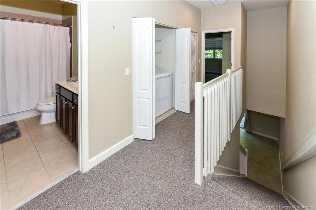 9726 Southwest Purple Martin Way Stuart, FL 34997 - Photo 14 of 30 a view of a hallway with a livingroom and a refrigerator