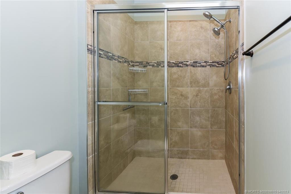 9726 Southwest Purple Martin Way Stuart, FL 34997 - Photo 18 of 30 a bathroom with a shower