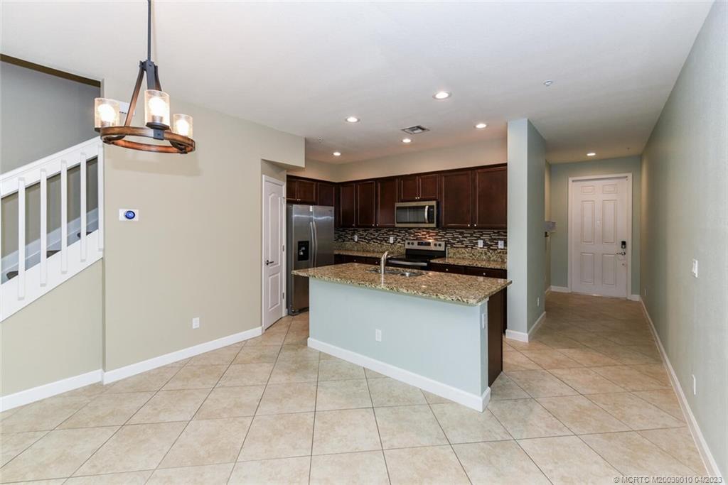 9726 Southwest Purple Martin Way Stuart, FL 34997 - Photo 5 of 30 a view of kitchen with stainless steel appliances granite countertop a refrigerator oven a sink and dishwasher