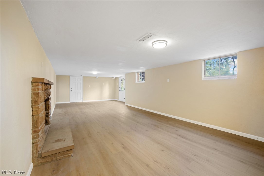 154 Winchester Road Akron, OH 44333 - Photo 24 of 26 Basement with light hardwood / wood-style floors and a fireplace