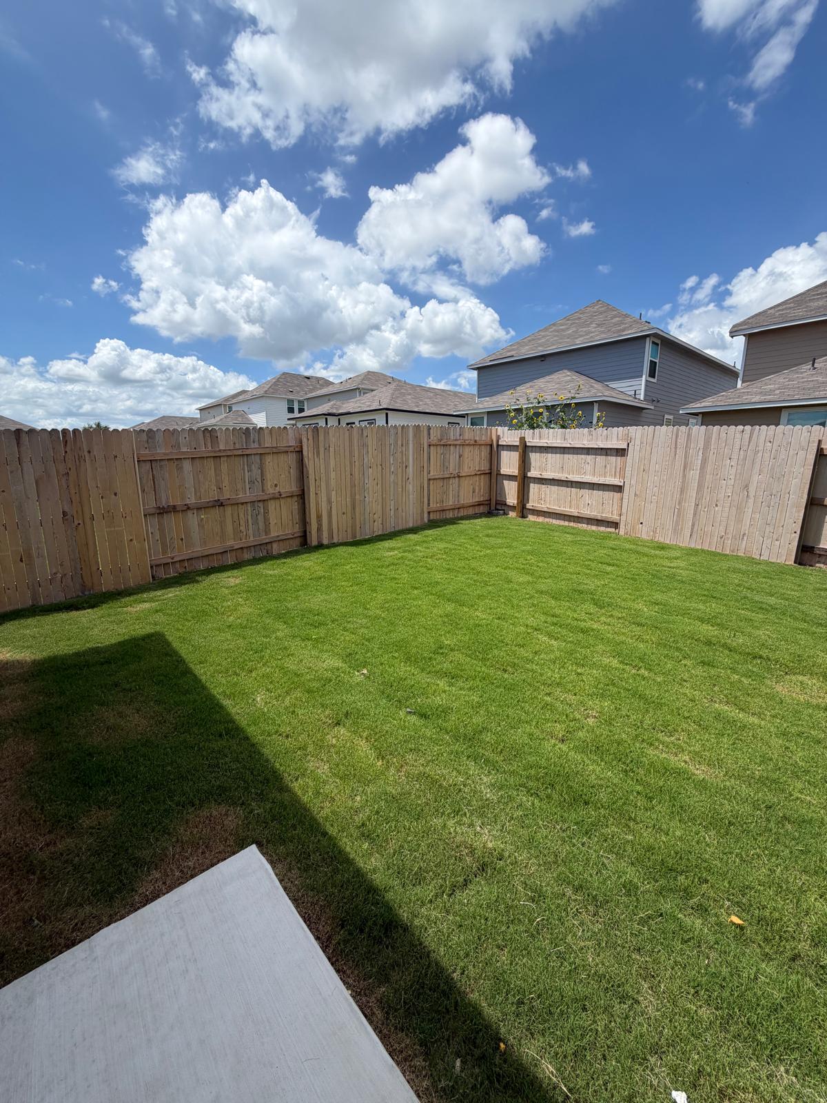 2612 Towy Road Manor, TX 78653 - Photo 31 of 35 A verdant, private yard enclosed by a wood fence, perfect for outdoor activities.