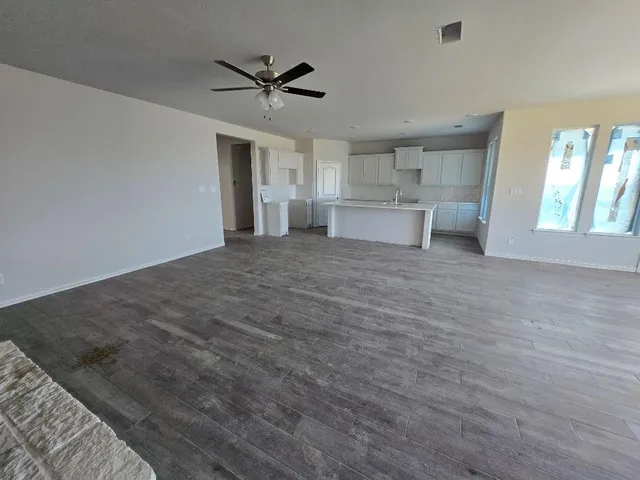 a view of a livingroom with a ceiling fan and window