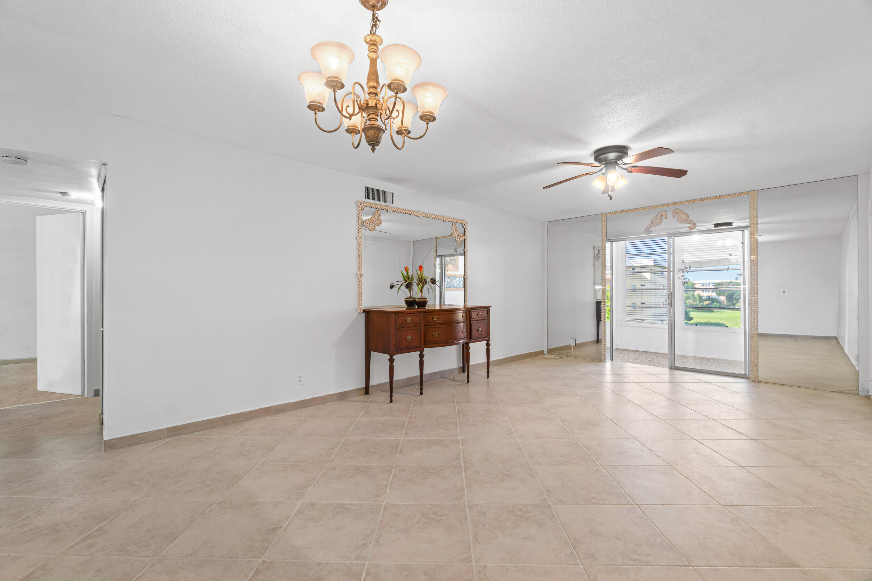 2615 Northeast 1st Court, Unit 303 Boynton Beach, FL 33435 - Photo 18 of 42 a view of a livingroom with a chandelier fan
