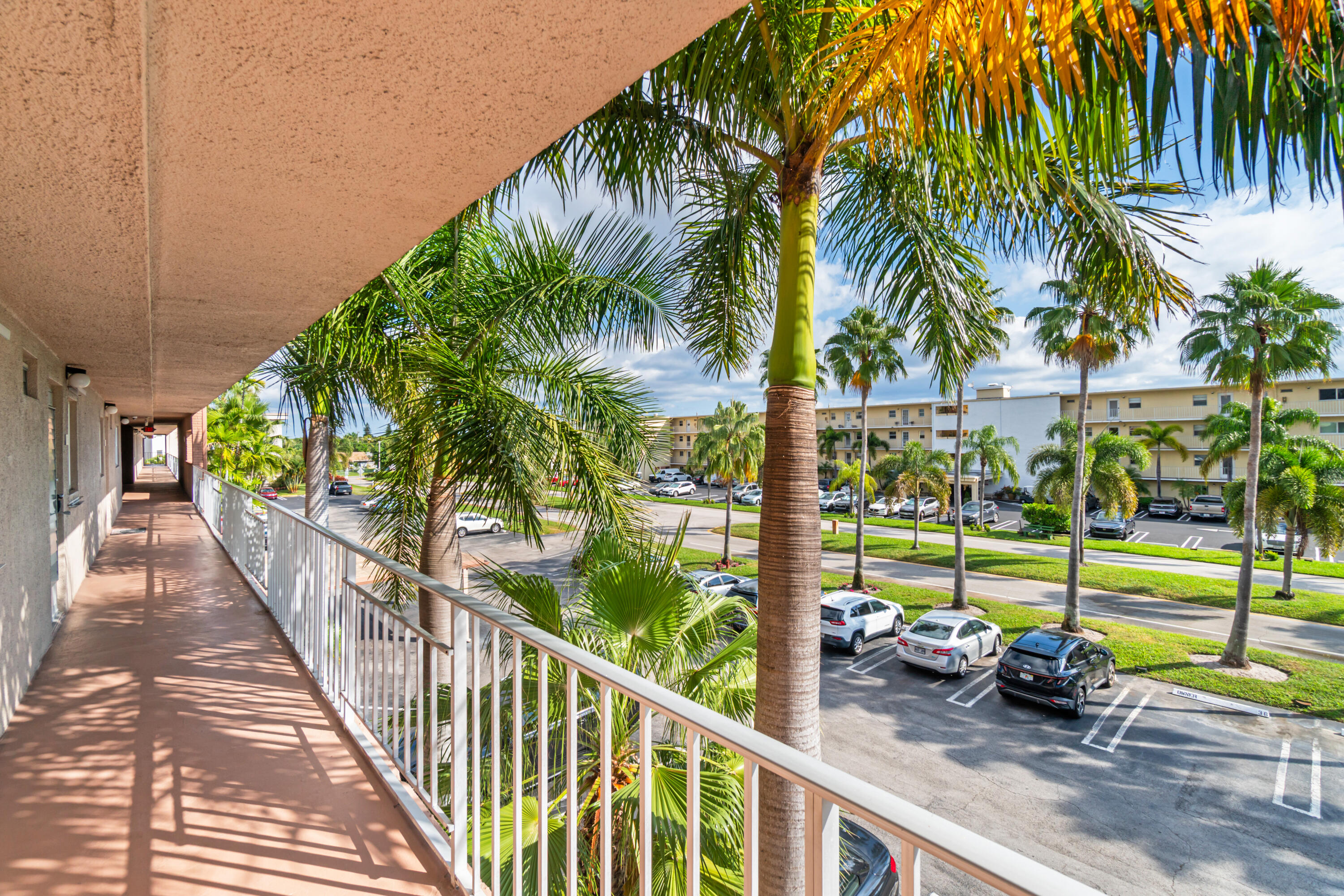 2615 Northeast 1st Court, Unit 303 Boynton Beach, FL 33435 - Photo 4 of 42 a view of a small yard from a balcony