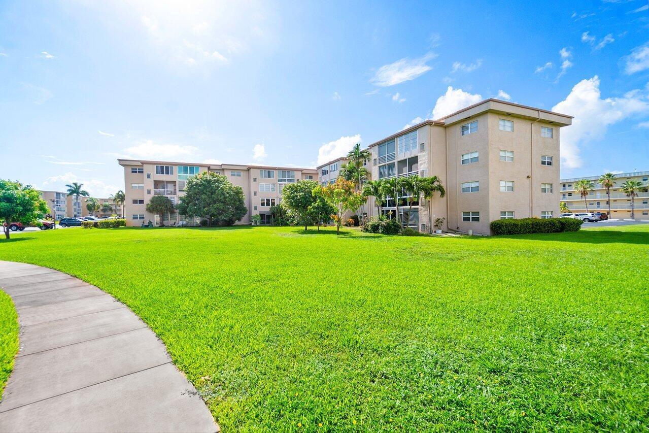 2615 Northeast 1st Court, Unit 303 Boynton Beach, FL 33435 - Photo 9 of 42 a view of a house with garden and yard