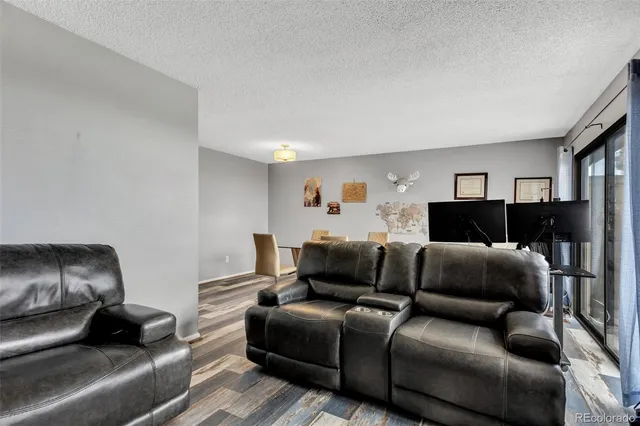 a view of a livingroom with furniture and floor to ceiling window