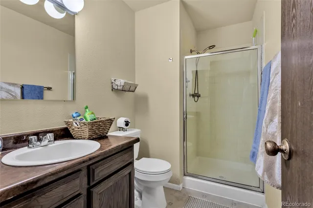 a living room with furniture a fireplace and a potted plant