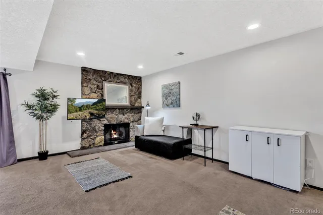 a living room with furniture a flat screen tv and a potted plant